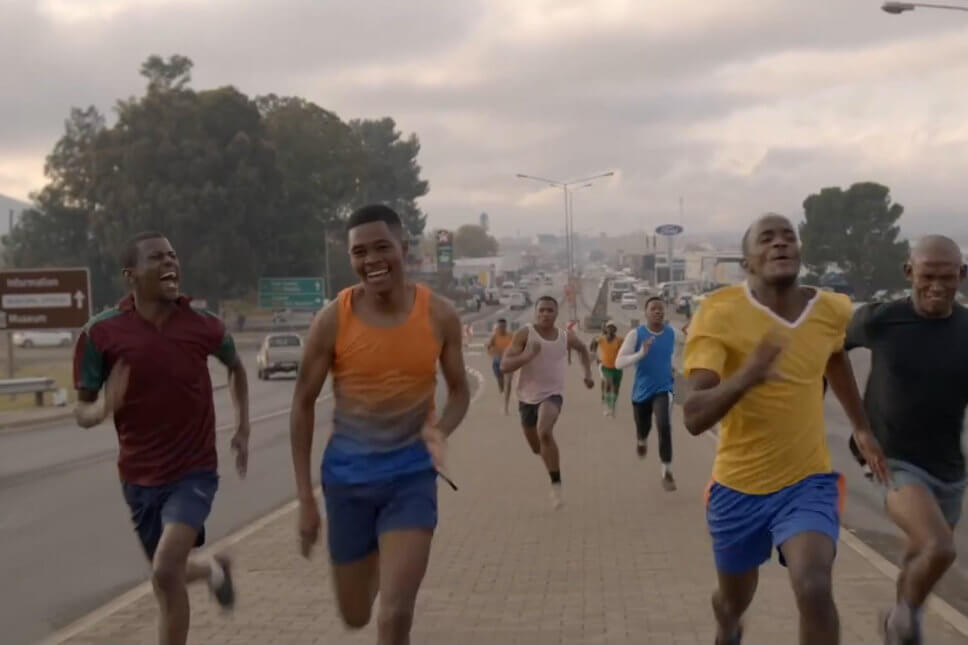 Men running a marathon race in the streets of Queenstown