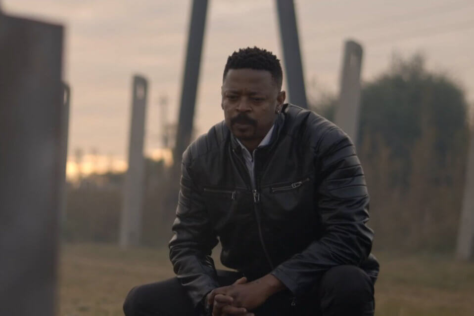 A man sitting and looking thoughtfully in a park