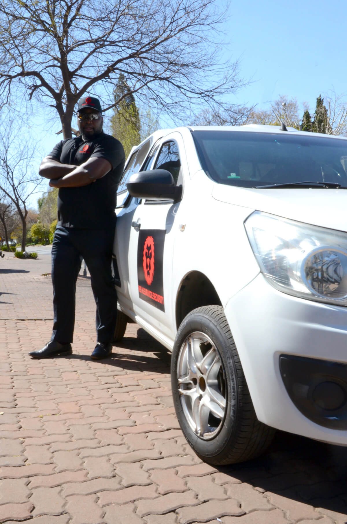 Security guard standing next to patrol car